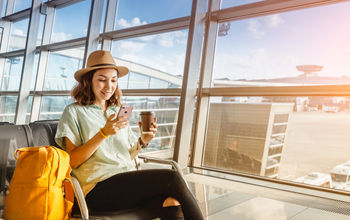 Traveler using her phone at the airport