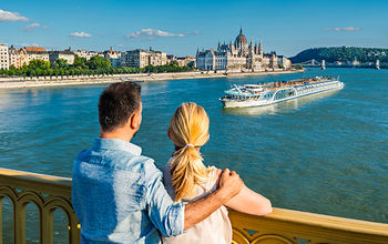 A couple looks out over the river.