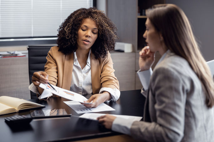 African-American travel agent working with client