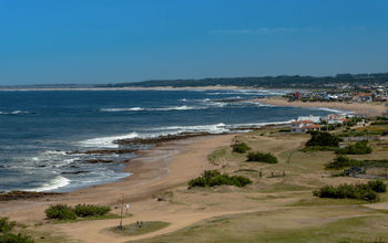 The beaches of Uruguay invite visitors to rest and enjoy them with their families. (Photo via MarcosMartinezSanchez/iStock/Getty Images Plus).