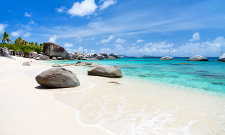 Beautiful tropical beach with white sand, turquoise ocean water and blue sky at Virgin Gorda, British Virgin Islands in Caribbean (Photo via shalamov / iStock / Getty Images Plus)