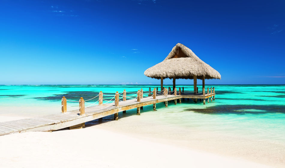 Beautiful gazebo on the tropical white sandy beach in Punta Cana, Dominican Republic (Photo via  Preto_perola / iStock / Getty Images Plus)