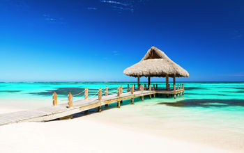 Beautiful gazebo on the tropical white sandy beach in Punta Cana, Dominican Republic (Photo via  Preto_perola / iStock / Getty Images Plus)