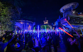 Guests brandish their lightsabers at the 'Disneyland After Dark: Star Wars Nite' event.