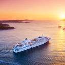 Cruise ship sailing into sunset