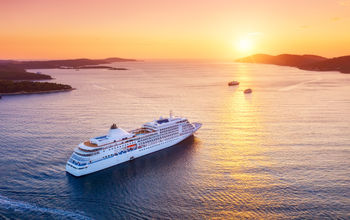 Cruise ship sailing into sunset