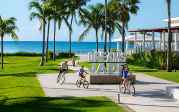 A family biking at Dreams Jade Resort & Spa