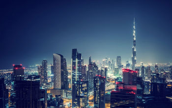 Beautiful Dubai cityscape, bird&#39;s eye view on a night urban scene, modern city panoramic landscape, United Arab Emirates (photo via Anna_Om / iStock / Getty Images Plus)