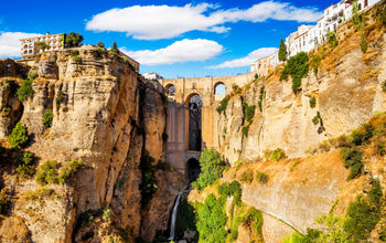 Panoramic view of the old city of Ronda, one of the famous white villages in the province of Malaga, Andalusia, Spain (photo via MarquesPhotography / iStock / Getty Images Plus)