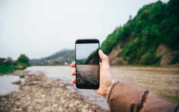 Traveler taking a picture for social media