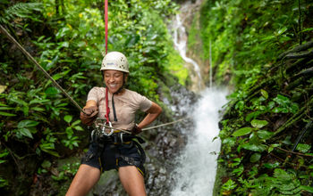 G Adventures guest zip-lining during the Solo-ish Costa Rica tour.