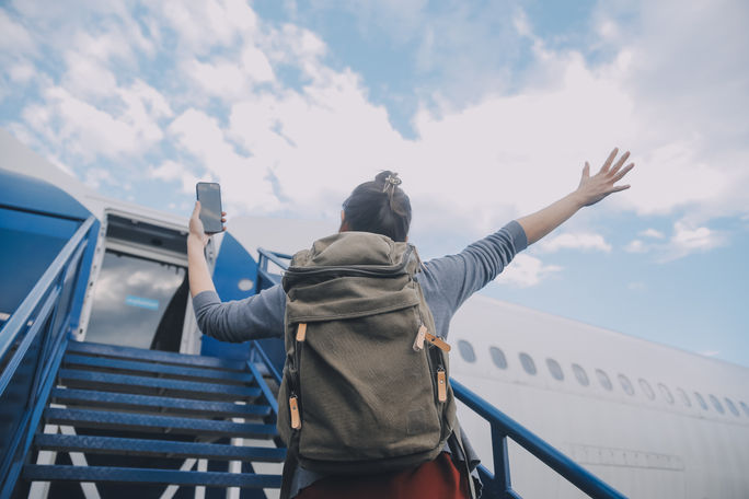 Happy traveler boarding a plane