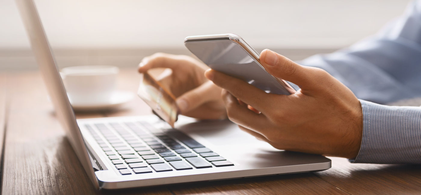 Image: A man booking travel online. (Photo Credit: Prostock-studio / Adobe Stock)