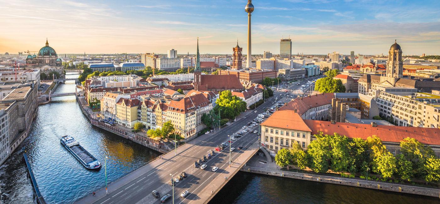 Image: Aerial view of Berlin skyline with famous TV tower and Spree river in beautiful evening light at sunset, Germany. (photo via bluejayphoto/iStock/Getty Images Plus)