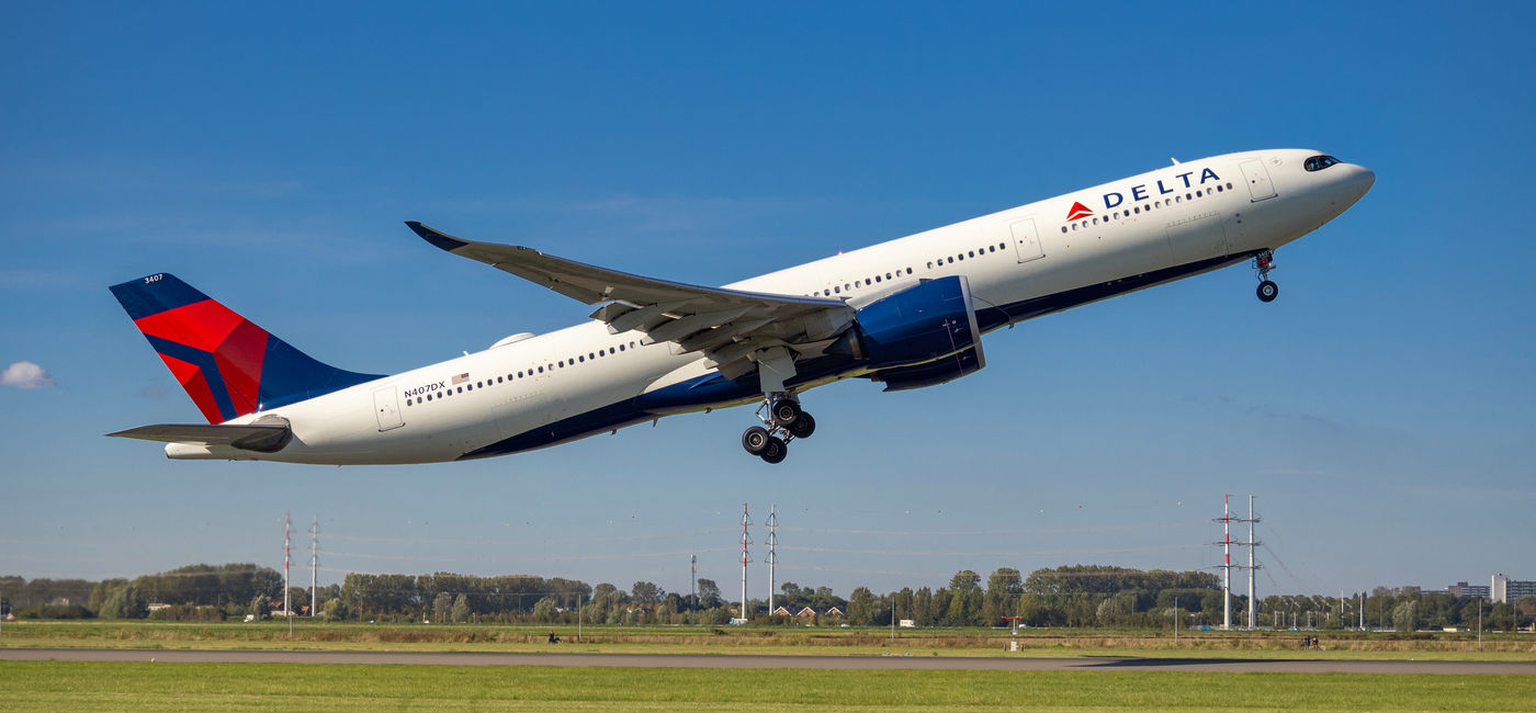 Image: Delta Air Lines plane taking off from Amsterdam's Schiphol Airport. (Photo Credit: kamilpetran/Adobe)