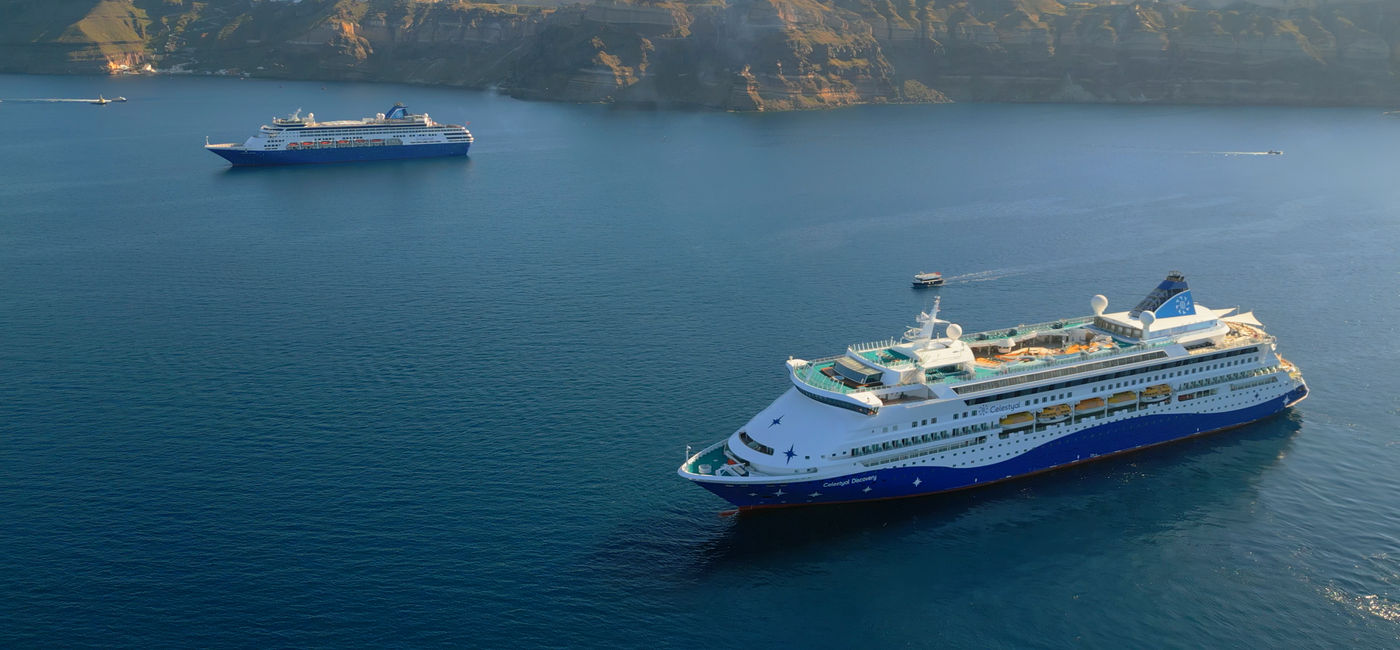 Image: The Celestyal Journey and Celestyal Discovery sailing off the coast of Santorini. (Photo Credit: Celestyal)