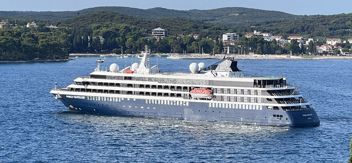 Image: The World Traveller ship as seen from Rovinj, Croatia. (Photo Credit: Photo by Paul J. Heney.)