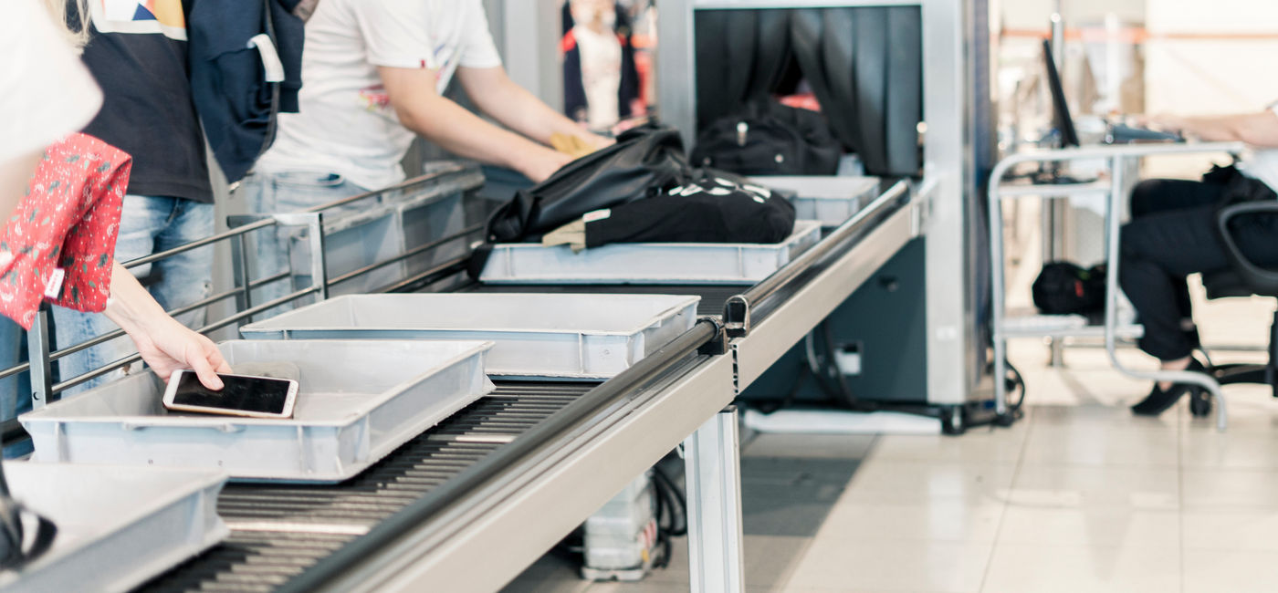 Image: Travelers passing through a TSA Airport Security scanning system. (Photo Credit: Adobe Stock/Mihail)