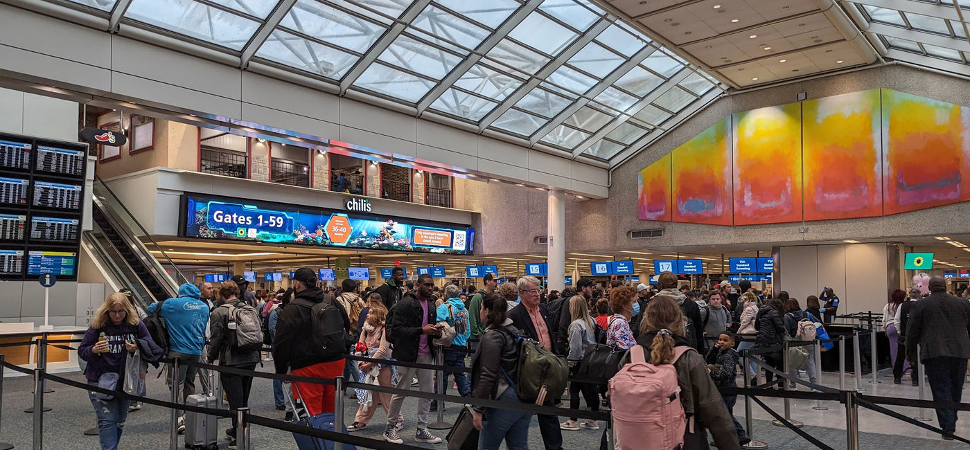 Image: Travelers wait in TSA security line at Orlando International Airport (Photo Credit: Eric Bowman)