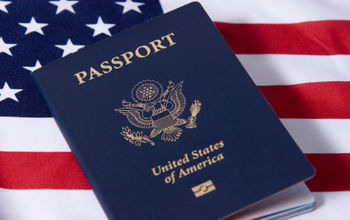 U.S. passport sitting atop an American flag.