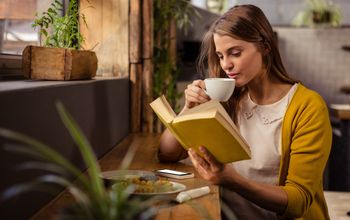 reading, woman reading, solo traveler, book, cafe