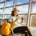 Traveler using her phone at the airport