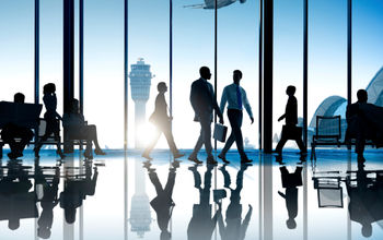 Corporate or business travelers walking through the airport.