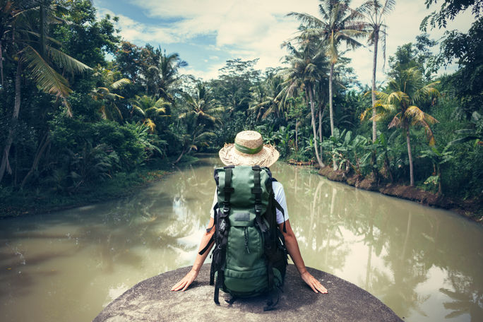 Woman sitting on the edge of a river